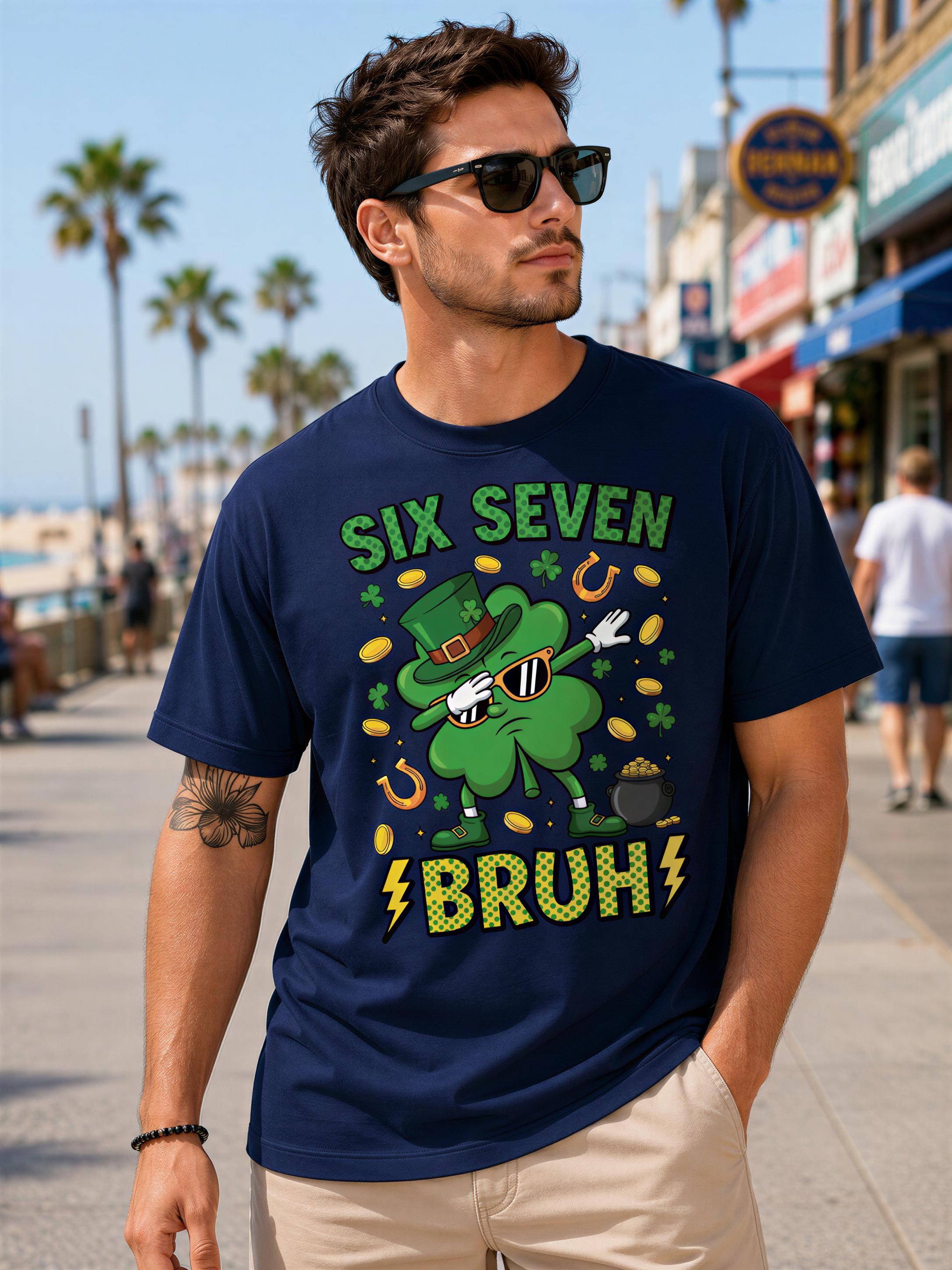 A man wearing a navy blue t-shirt with a graphic design of a green clover character and the text "Six Seven Brut" printed on it.