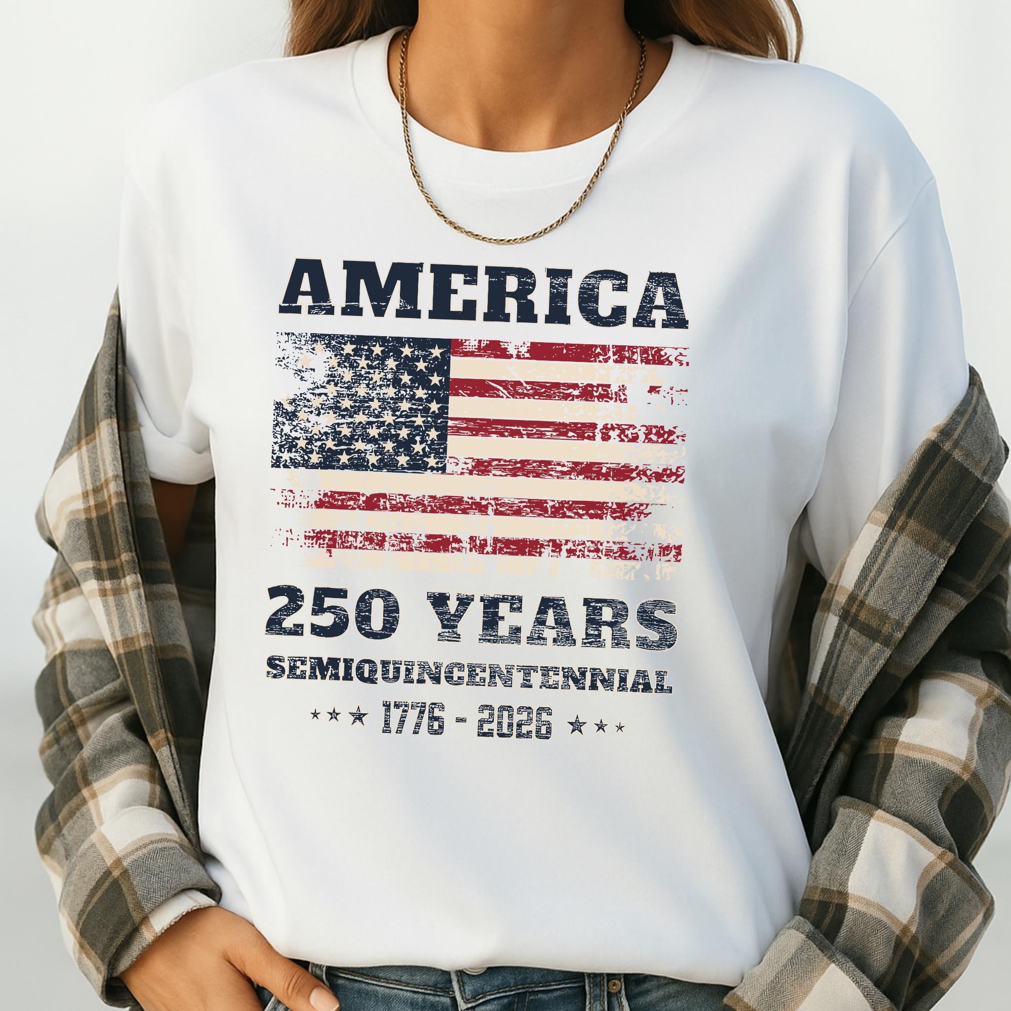 A person wearing a white t-shirt with a graphic design featuring the American flag and the text "AMERICA 250 YEARS SEMIQUINENTIAL 1776-2026".