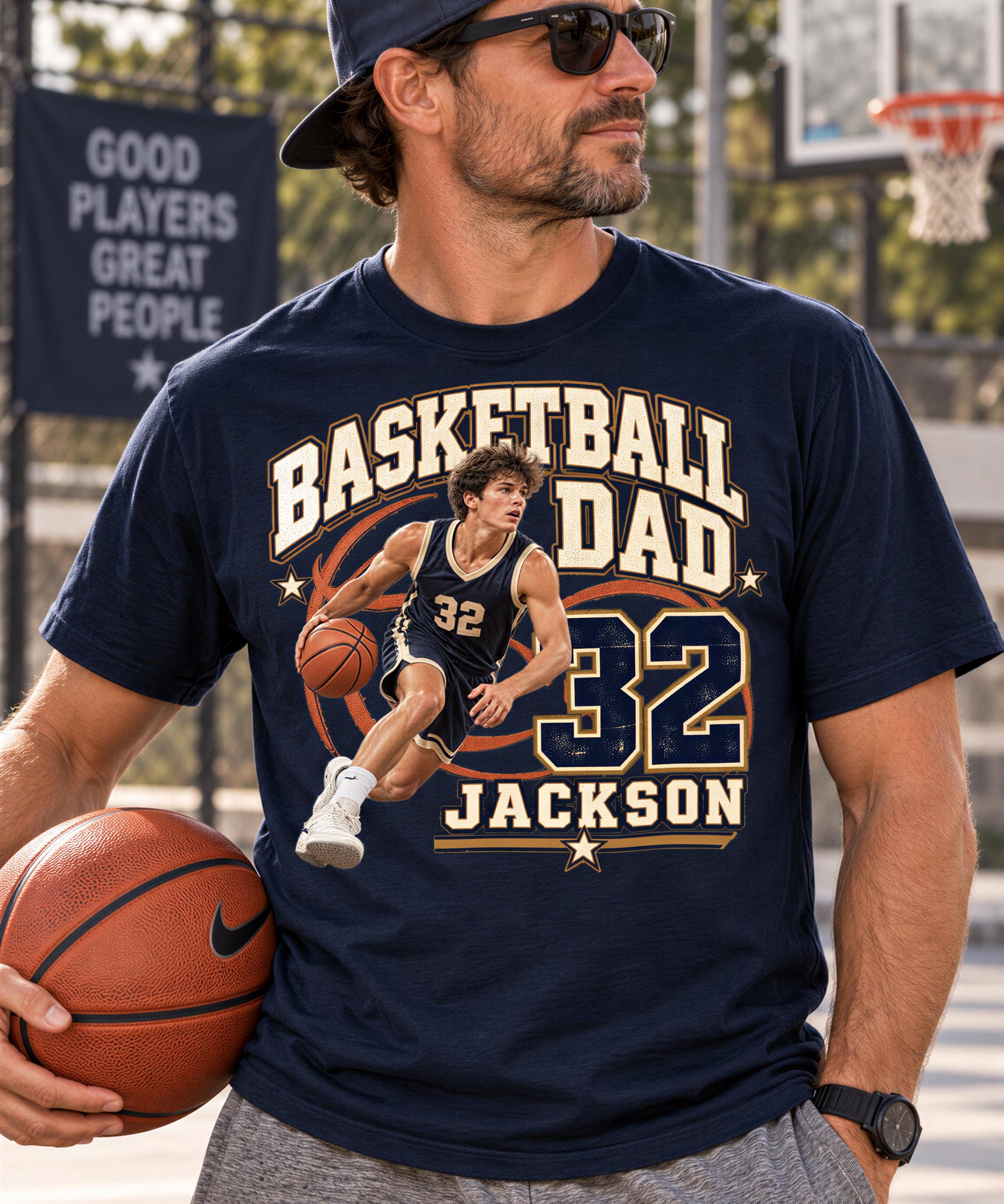 A man wearing a black t-shirt with a basketball player graphic and the text "BASKETBALL DAD 32 JACKSON" is holding a basketball.