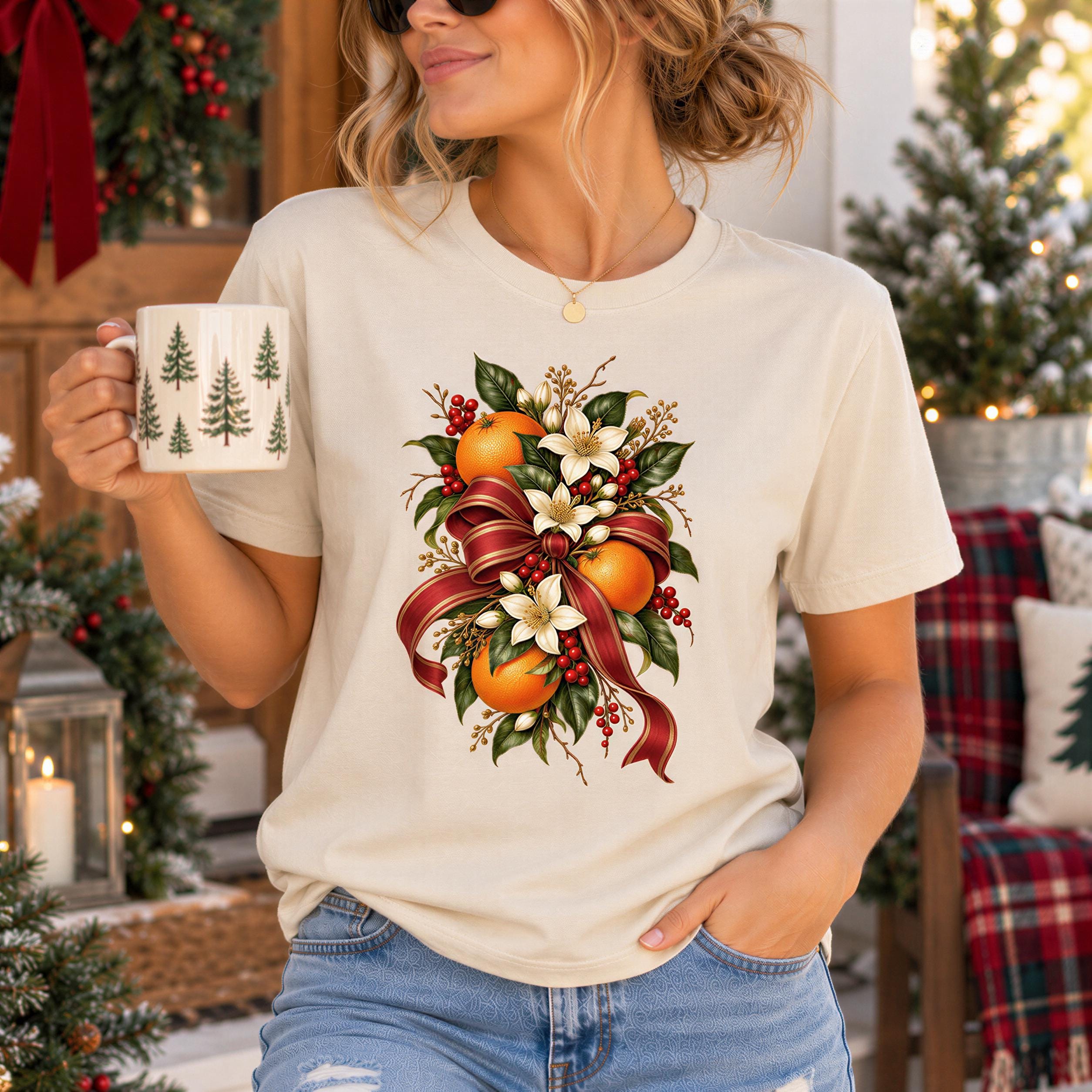 A woman wearing a white t-shirt with a floral design holding a coffee mug, standing in front of a Christmas tree and other holiday decorations.