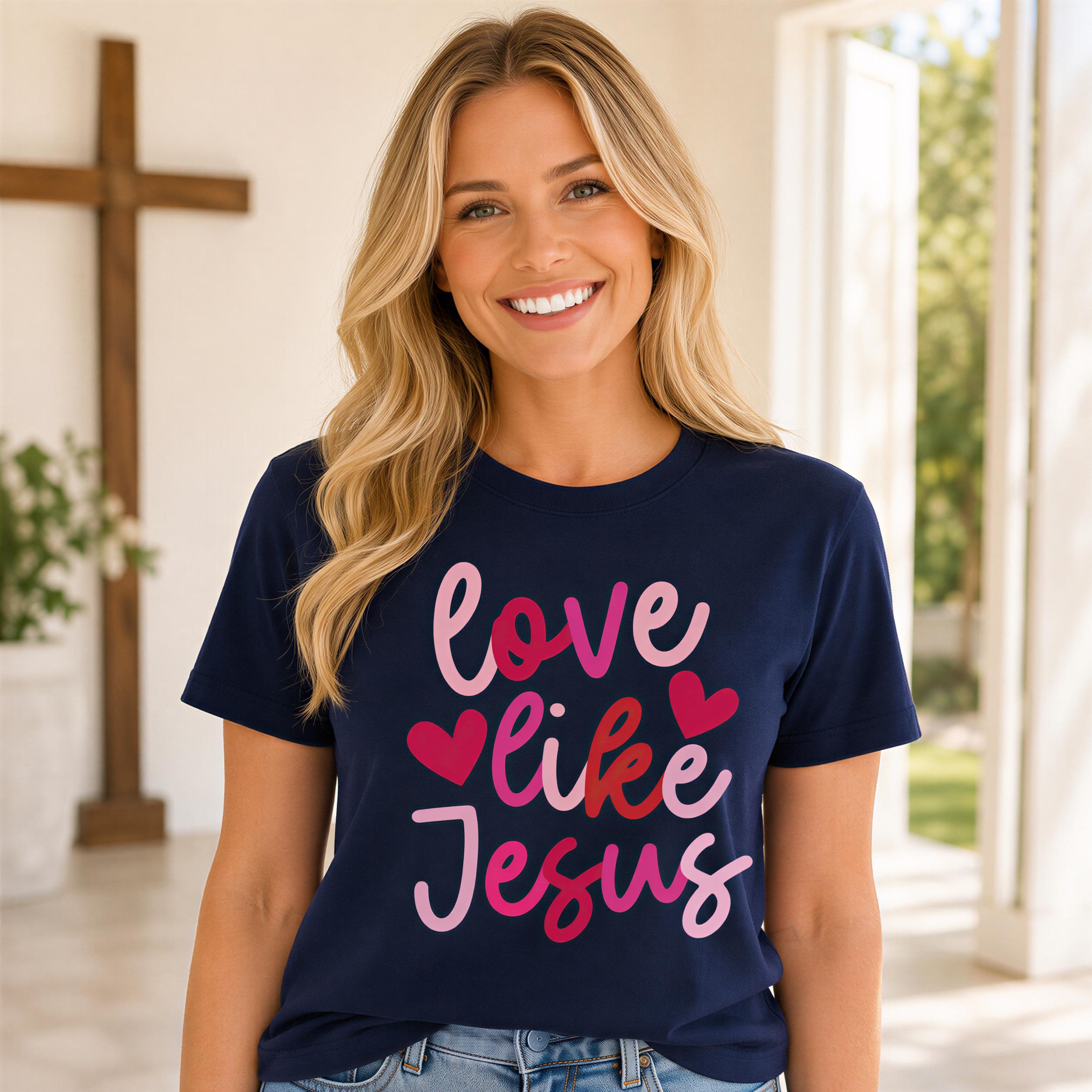 A smiling woman wearing a navy blue t-shirt with the text "love like Jesus" printed on it.