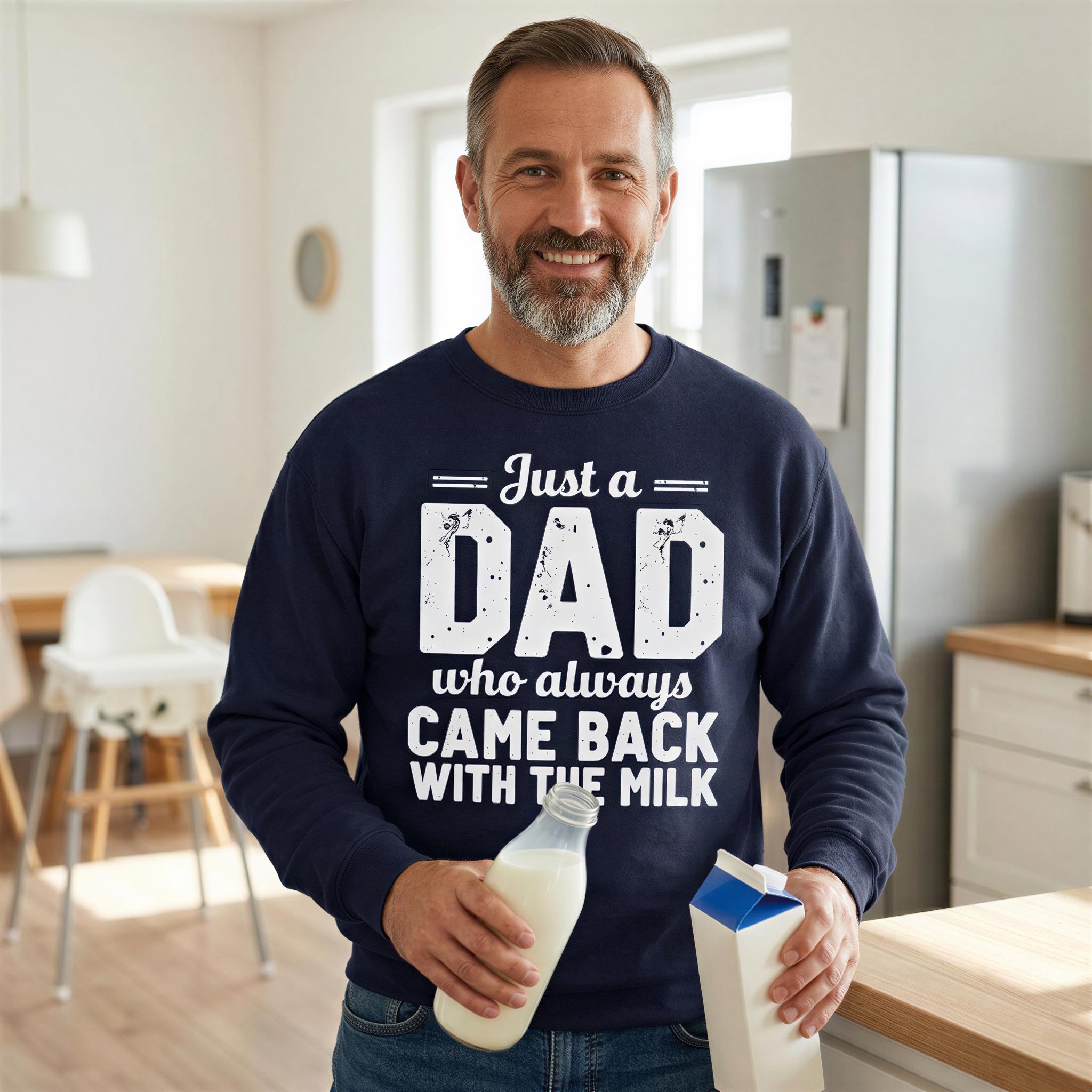 A man wearing a navy blue sweatshirt with the text "Just a DAD who always came back with the milk" is standing in a kitchen, holding a bottle of milk and a carton.