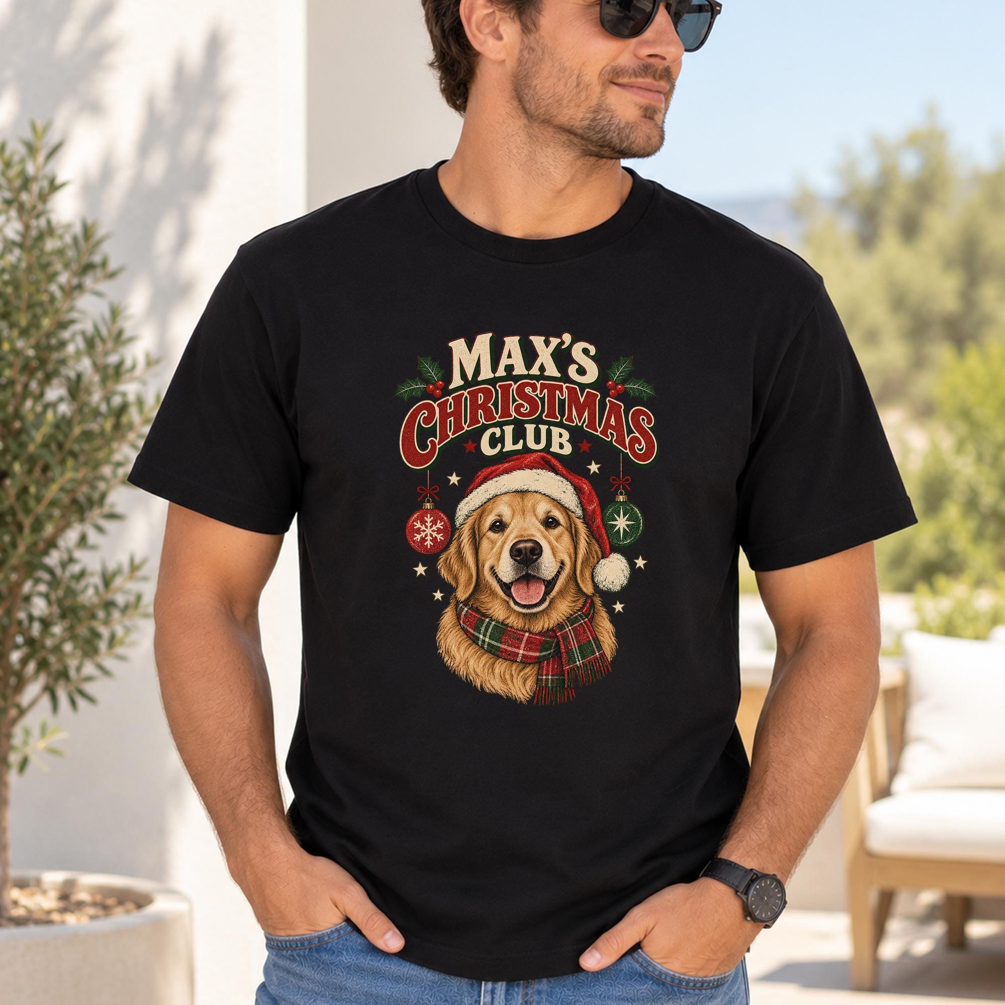 A man wearing a black t-shirt with a graphic of a dog wearing a Santa hat and scarf, along with the text "Max's Christmas Club".