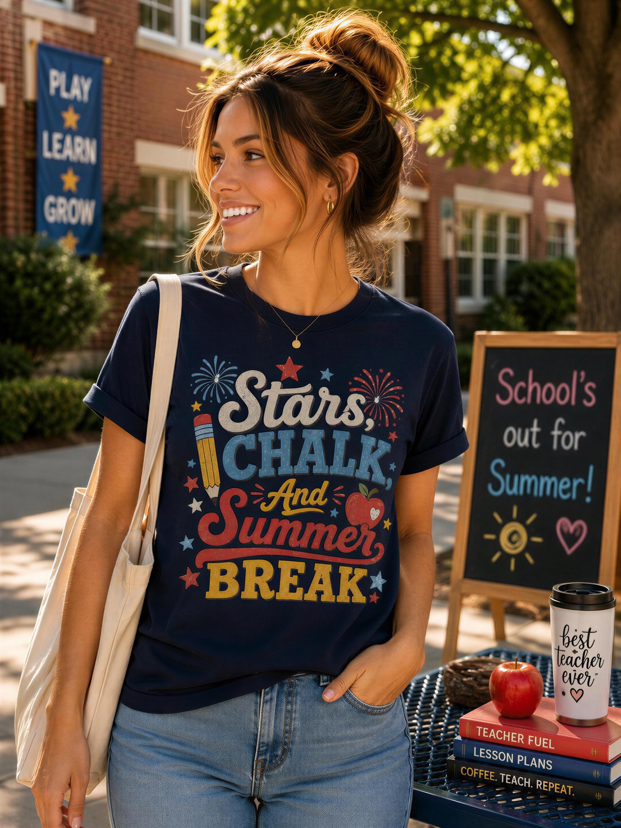 A woman wearing a blue t-shirt with a colorful design stands in front of a chalkboard sign that says "School's out for summer!" and a stack of books.