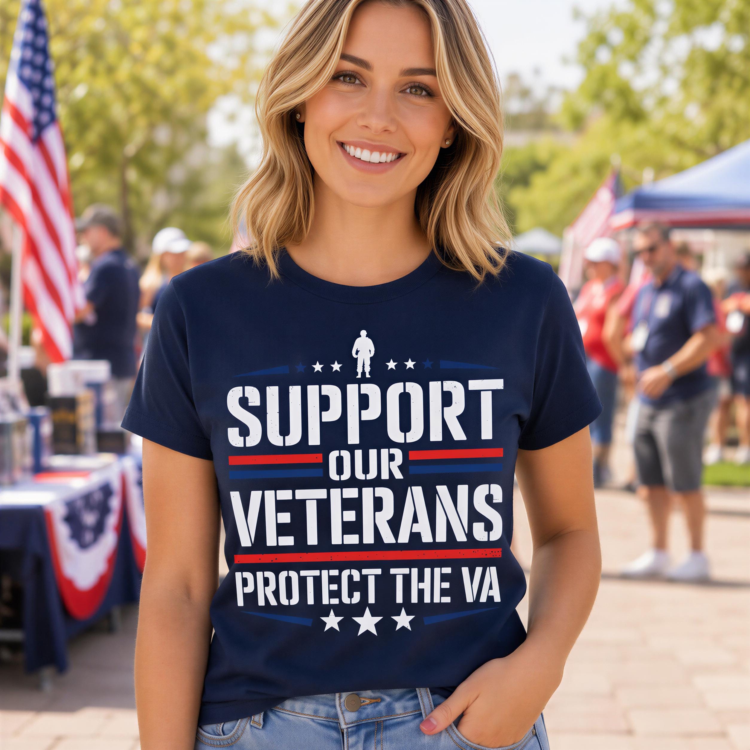 A woman wearing a navy blue t-shirt with the text "SUPPORT OUR VETERANS PROTECT THE VA" stands in front of an American flag and a tent.
