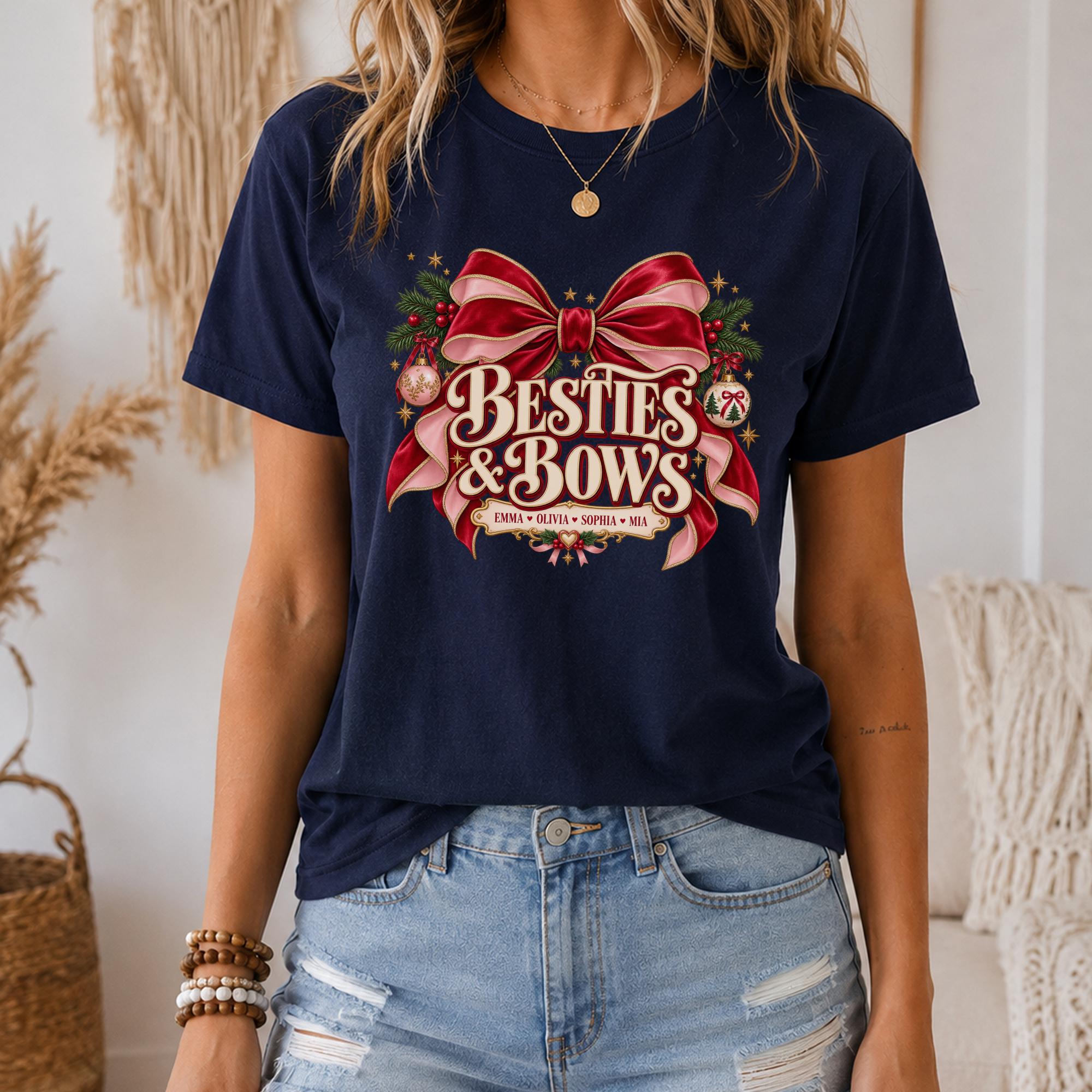 A woman wearing a navy blue t-shirt with a graphic design featuring a large red bow and the text "Besties & Bows" printed on it.