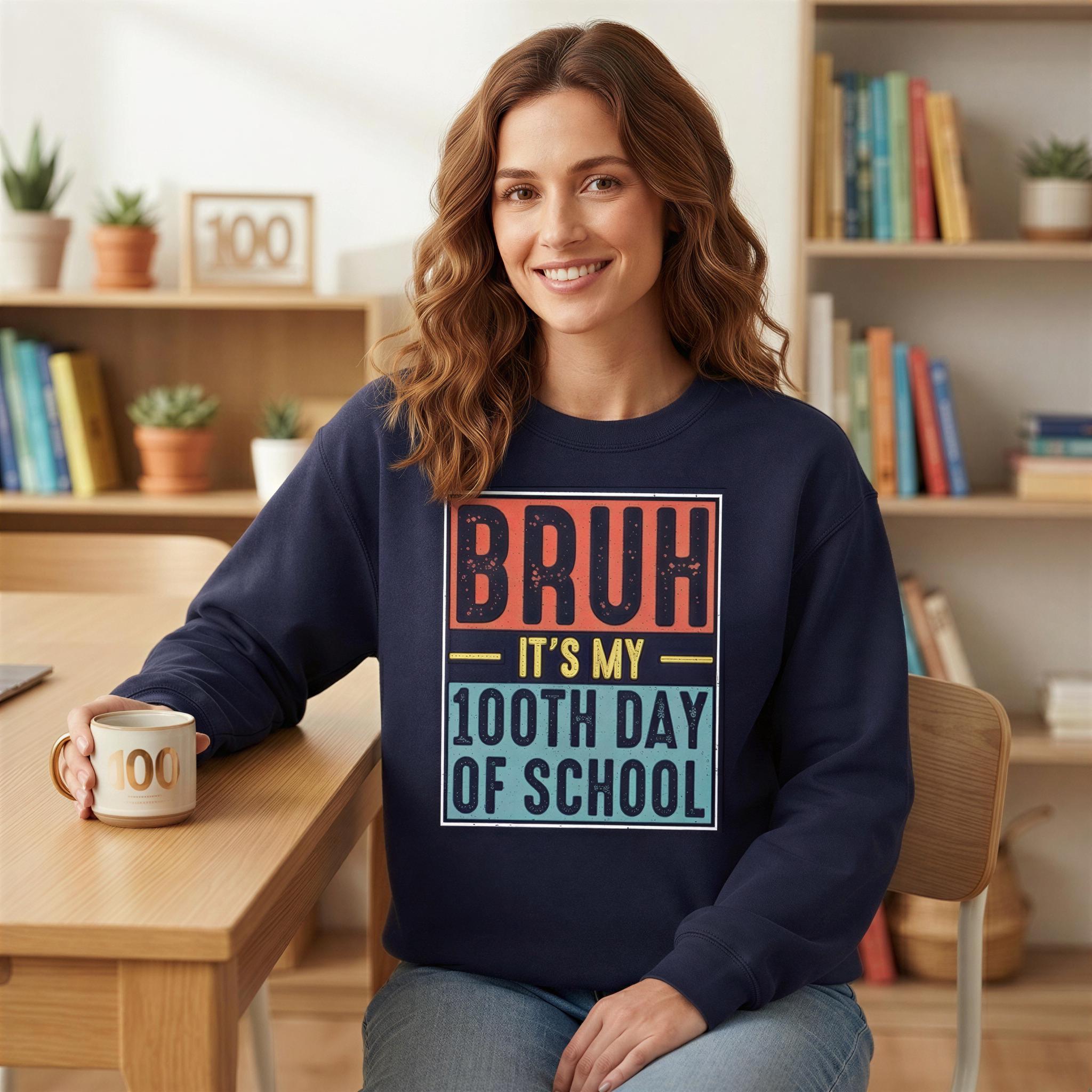 A woman wearing a blue sweatshirt with a humorous text printed on it, sitting at a desk in a room with bookshelves in the background.