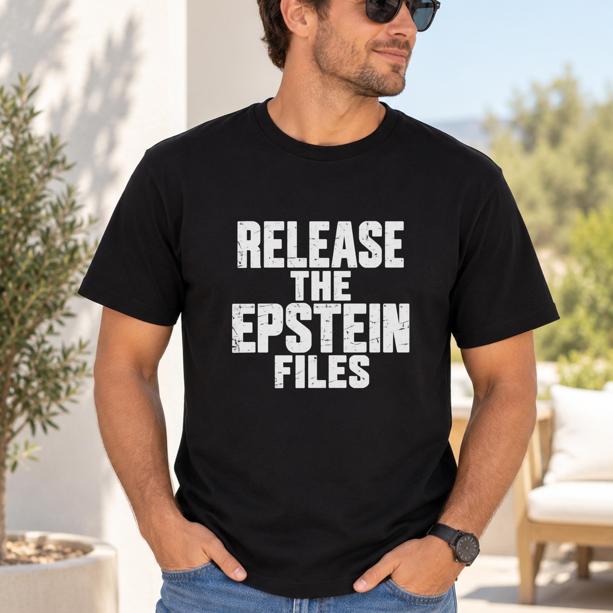 A man wearing a black t-shirt with the text "RELEASE THE EPSTEIN FILES" printed on it.