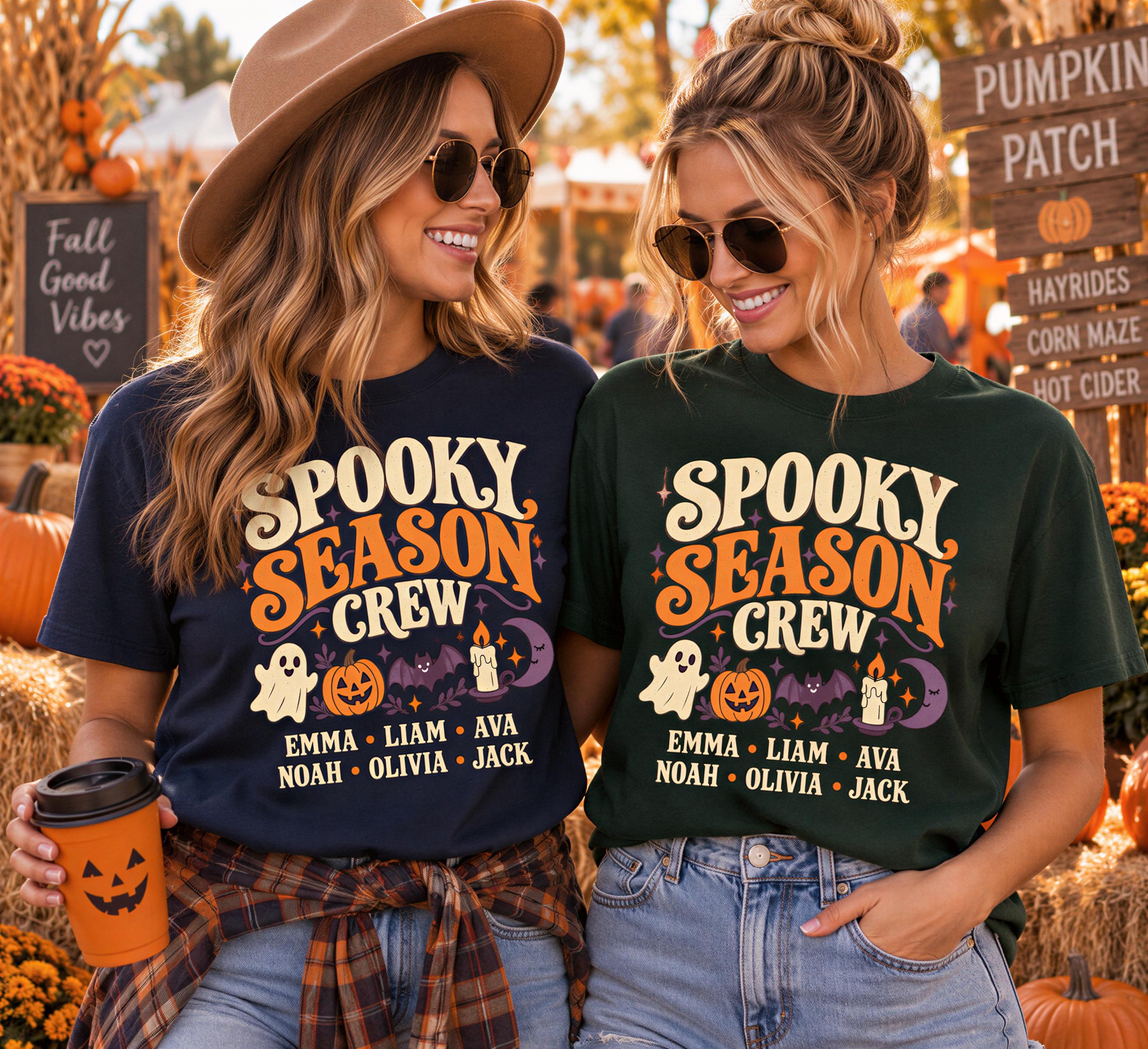 Two women wearing matching "Spooky Season Crew" t-shirts stand together, smiling and holding drinks, with a pumpkin patch and fall decorations visible in the background.
