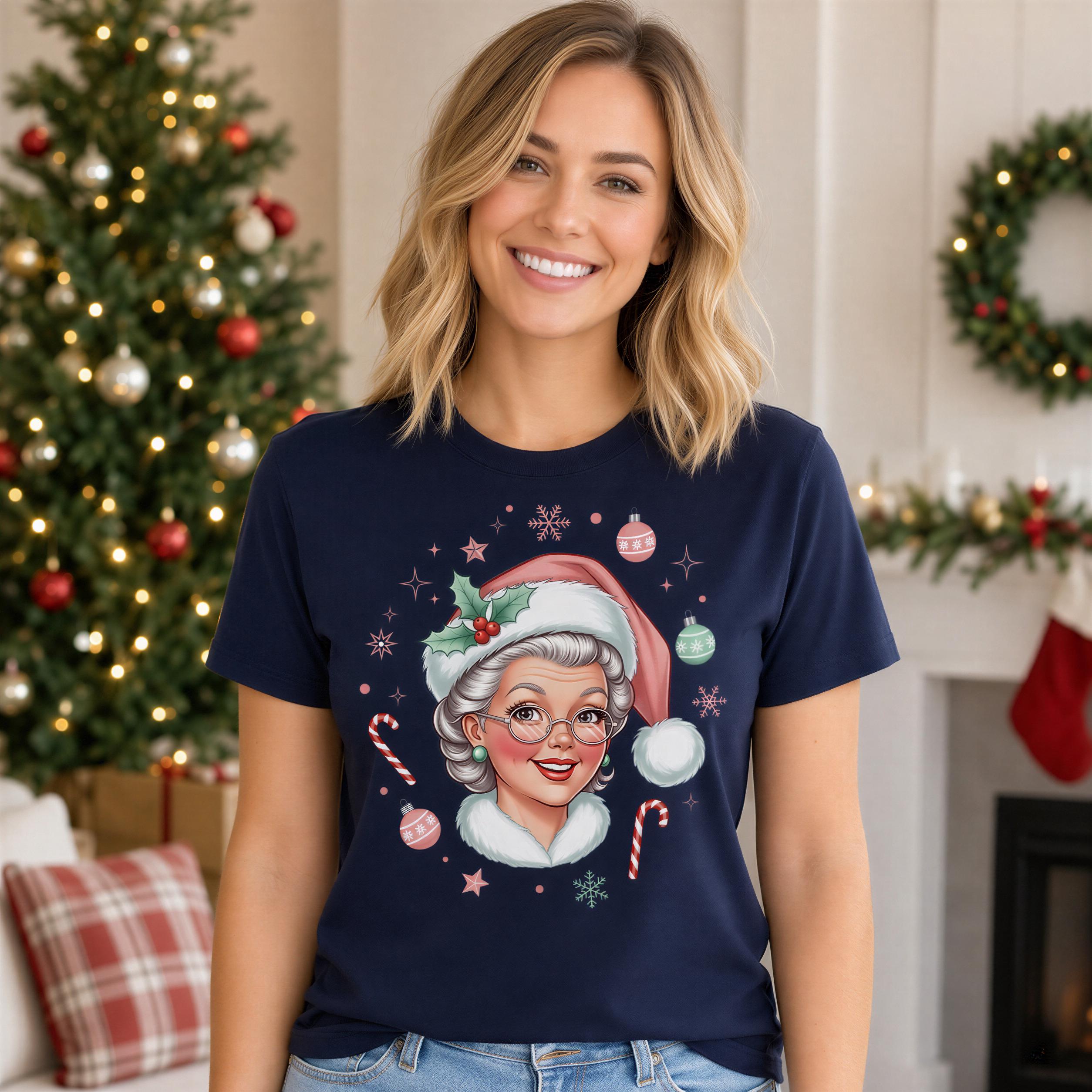 A smiling woman wearing a navy blue t-shirt with a Christmas-themed graphic of a woman wearing a Santa hat and surrounded by Christmas decorations.