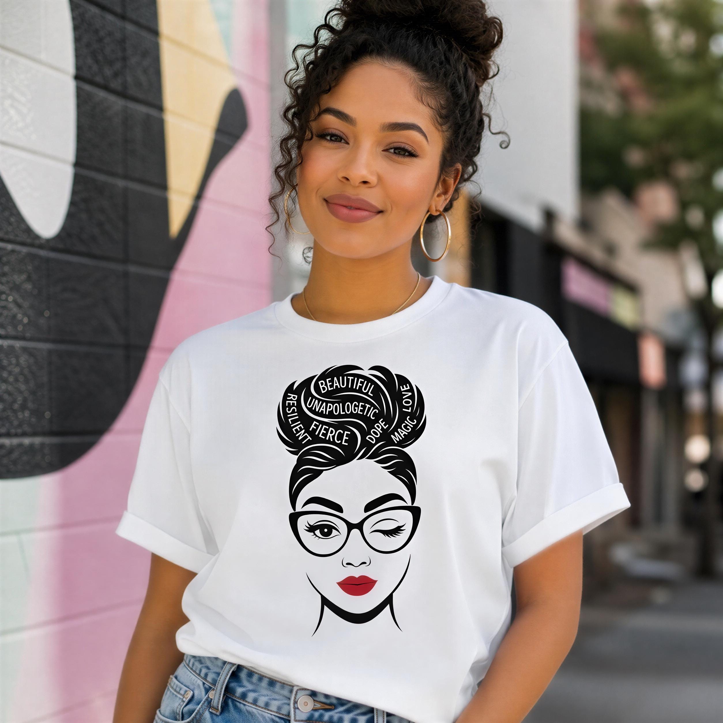 A young woman wearing a white t-shirt with a graphic design of a woman's face and the text "Beautiful Unpolarized Percep" printed on it, standing in front of a colorful mural.