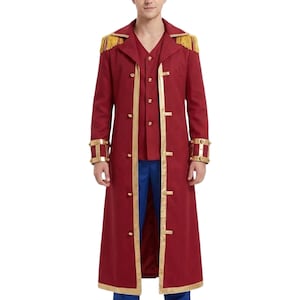 May include: A long, deep red coat featuring gold trim along the front opening and hem. The coat includes gold fringe epaulets on the shoulders, gold buttons down the front, and gold-toned cuffs with a cage-like design on the long sleeves.