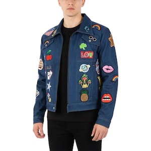 May include: A blue denim jacket adorned with colorful patches, including a rainbow, lips, and the word "LOW". The jacket has a zipper closure and a classic collar. The patches add a unique, artistic flair to the jacket.