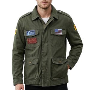 May include: Olive green jacket with multiple pockets and patches. The jacket features a US flag patch and text that reads "FAST END" and "Gather". The jacket has a button-down collar and a zipper closure.