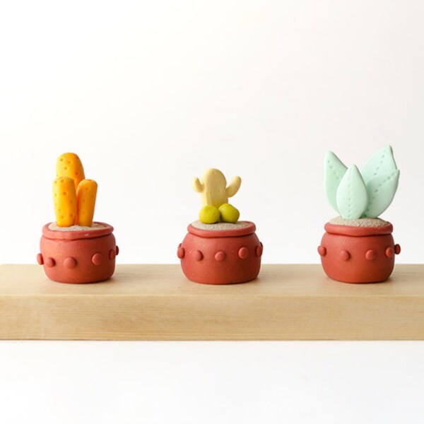Artificial plant figurines, set of 3  sculptures on wood base,  clay cactus