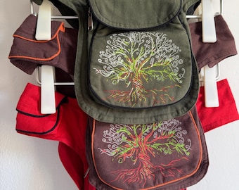 May include: Three waist bags in olive green, brown, and red, each featuring a white and green embroidered tree design on the front flap. The bags have zippered compartments, adjustable straps, and are displayed hanging from white plastic clips.