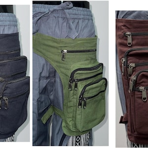 May include: Hip bags in black, olive green, and burgundy. Each bag has multiple zippered compartments and a strap that secures around the waist and thigh. The bags are made of a durable fabric.