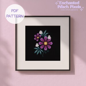 May include: A framed cross stitch pattern titled Enchanted Peach Pixels featuring a black background with purple flowers, green leaves, and three small white ghost figures. The design is presented as a PDF pattern for digital download.