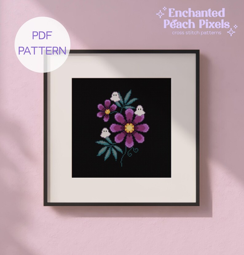 May include: A framed cross stitch pattern titled Enchanted Peach Pixels featuring a black background with purple flowers, green leaves, and three small white ghost figures. The design is presented as a PDF pattern for digital download.