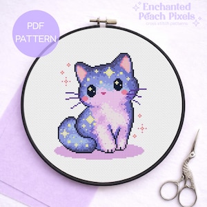 May include: A cross-stitch pattern of a cute cat with a starry design, in a black embroidery hoop. The cat is primarily purple and blue, with yellow star accents. The text "PDF PATTERN" is in a purple circle. The text "Enchanted Peach Pixels" is also visible.