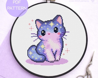 May include: A cross stitch pattern in a black embroidery hoop featuring a pixel art cat with purple and blue fur, yellow stars, and pink cheeks. The text reads PDF PATTERN and Enchanted Peach Pixels cross stitch patterns.
