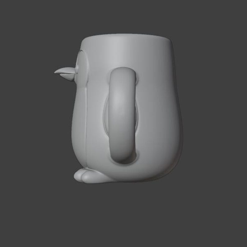 May include: A gray ceramic mug shaped like a penguin. The mug has a rounded body, a curved handle, and a small beak. The penguin's feet are visible at the base of the mug.