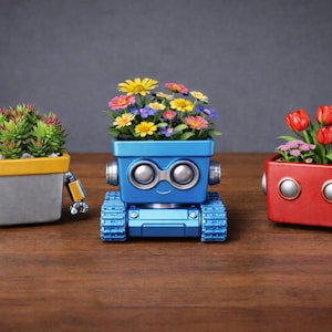 May include: Three robot-shaped planters, each holding different flowers. The planters are gray, blue, and red, with yellow, silver, and blue accents. The flowers include succulents, colorful mixed blooms, and red tulips. The planters are on a wooden surface.