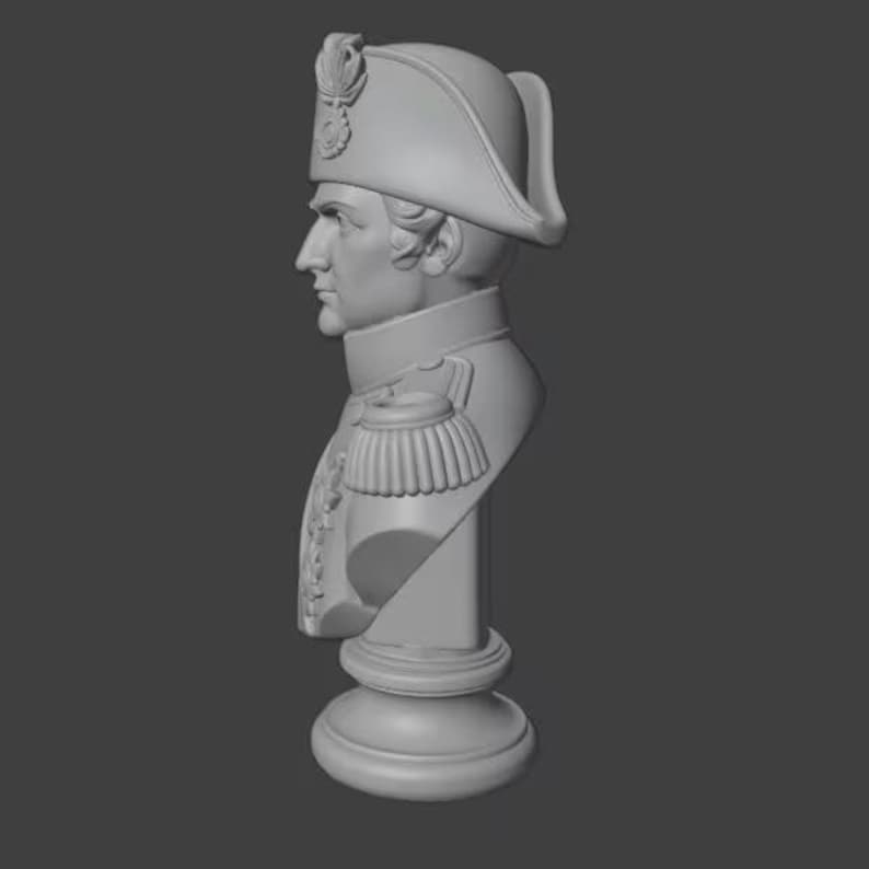 May include: A gray bust of a historical figure, wearing a bicorne hat and military-style jacket with epaulettes. The bust is mounted on a pedestal base, and the overall design is a classical style.