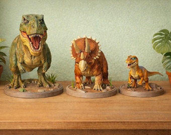 May include: Three detailed dinosaur figurines: a Tyrannosaurus Rex, a Triceratops, and a Velociraptor. The T-Rex is green and yellow, the Triceratops is brown, and the Velociraptor is orange. Each stands on a circular base, evoking a prehistoric theme.