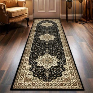 May include: A long, rectangular black rug with an ornate beige and brown floral pattern. The rug features a central design with repeating star-like medallions and a detailed border, suitable for a hallway or entryway.