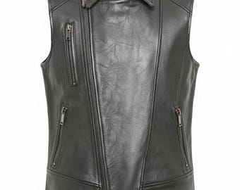 May include: Black leather vest with a collared neckline and multiple zippered pockets. The vest features an asymmetrical zipper closure and a tailored fit, suitable for layering. The vest is made of a smooth, textured leather material.