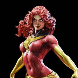 May include: A detailed statue of a female superhero with fiery red hair and a red and gold costume. The figure has a determined expression and is posed with arms outstretched. The background is black.