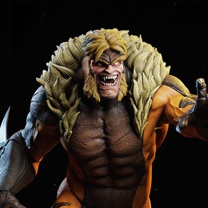 May include: A detailed figurine of Sabretooth, a Marvel Comics character. The figure has a muscular physique, with a yellow and brown color scheme. The character's face is snarling, with sharp teeth and a blonde mane.