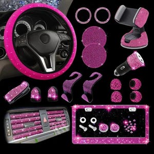 May include: A collection of pink rhinestone car accessories, including a steering wheel cover, air vent decorations, license plate frame, phone holder, and various other decorative items. The accessories are designed to add a touch of glamour to a vehicle's interior.