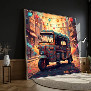 May include: A vibrant artwork depicts a colorful auto-rickshaw adorned with floral patterns, set against a festive street scene with string lights and buildings. The artwork is framed and leans against a dark wall, with a rug and side table in the foreground.