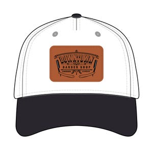May include: White baseball cap with a black brim. The cap features a brown rectangular patch with the words "Downtown Barber Shop" and barber tools. The text "Lawrence Kansas" is also on the patch.