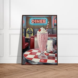 May include: A framed print of a diner scene. A pink milkshake with whipped cream and a cherry sits on a red and white checkered table. A neon sign reads "DINER". A jukebox and red booths are in the background.