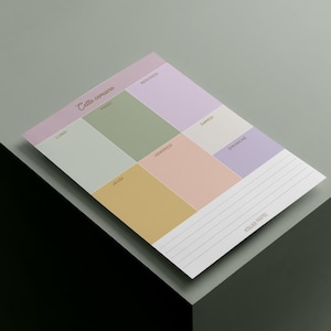 Könnte beinhalten: Ein pastellfarbener Wochenplaner mit Abschnitten für jeden Tag, einschließlich eines linierten Abschnitts für Notizen. Der Planer enthält den Text "Cette semaine" und "Atelier Nadie".