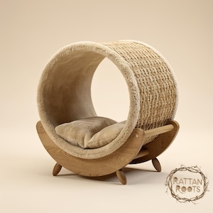 May include: A beige cat bed with a woven rattan exterior and a soft, plush interior. The bed is supported by a wooden rocking base and includes a matching beige cushion. The logo "Rattan Roots" is visible.