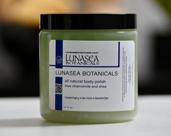 May include: A green jar of LunaSea Botanicals all natural body polish with blue chamomile and shea, rosemary, lemon, and lavender scents. The jar is labeled with the company's website and logo. It contains 8 fl. oz.
