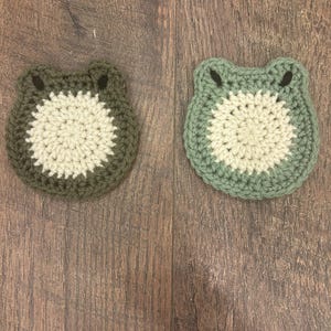 May include: A white ceramic mug with a black handle and the text "But First, Coffee" in a black, bold font. The mug is on a white surface. The mug is approximately 4 inches tall.