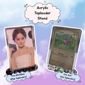 May include: Clear acrylic toploader stands displaying a KPop photo and a TCG card. The stands have a decorative base and hold cards that fit 65x93mm and 3x4 inch sizes. Text on the image reads "Acrylic Toploader Stand".