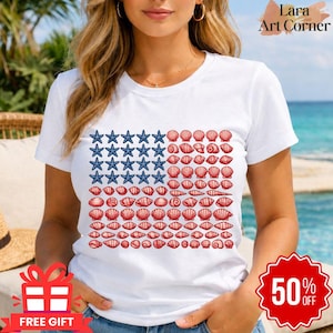Puede incluir: Una camiseta blanca de manga corta con un diseño gráfico de la bandera estadounidense compuesto por estrellas de mar azules y conchas rojas. El diseño está dispuesto en un patrón de cuadrícula rectangular en la parte frontal.