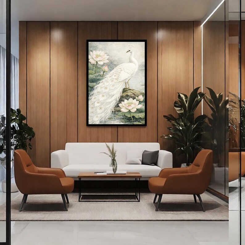 May include: A framed print of a white peacock with a long tail, standing on a rock surrounded by water lilies. The artwork is set in a room with a white sofa, brown armchairs, and a wooden coffee table. The room has wooden paneling.