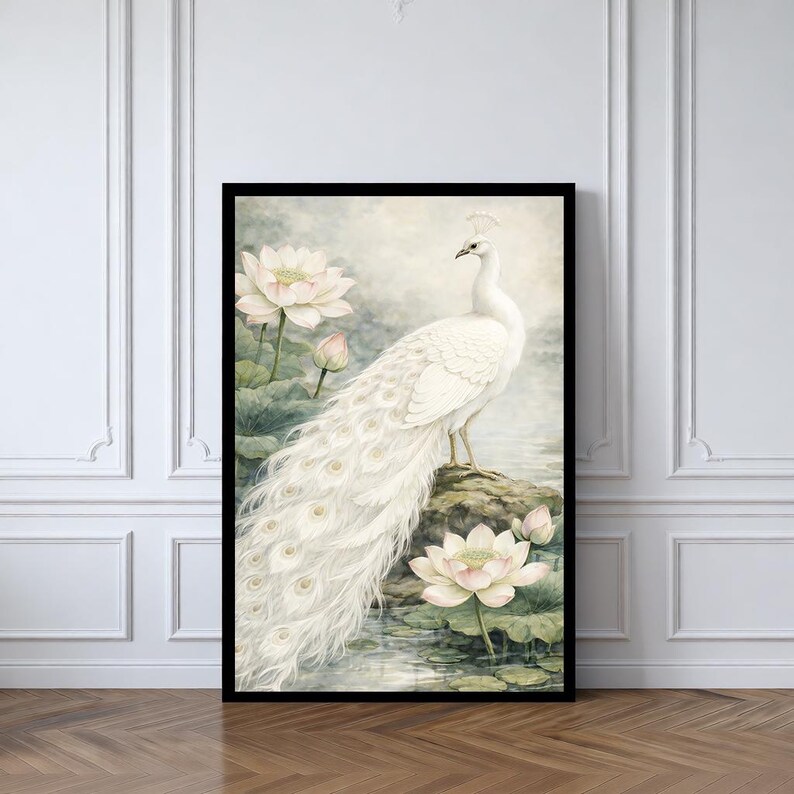 May include: Framed art print depicting a white peacock with a long tail, standing on a rock. The image includes white lotus flowers and green lily pads, rendered in a soft watercolour style. The background is a muted blend of colours.