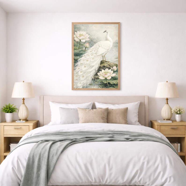 May include: A framed watercolour print featuring a white peacock with a long tail, standing on a rock near water lilies. The artwork has a soft colour palette and is displayed above a bed with neutral-toned bedding.