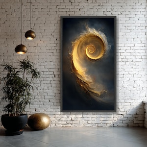 May include: A framed abstract art print featuring a golden spiral design against a dark blue background. The artwork has a textured, ethereal quality, with swirling patterns and gradients of gold and brown. The frame is dark gray, and the print is displayed on a white brick wall.
