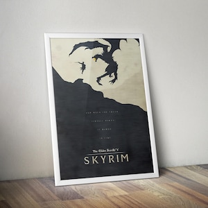 May include: Framed poster featuring a silhouette of a dragon and a figure, with text from The Elder Scrolls V: Skyrim. The artwork is in black and beige tones, with the game's title prominently displayed at the bottom.