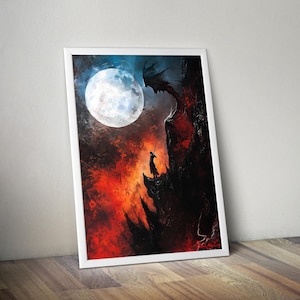 May include: Framed art print depicting a dramatic fantasy scene. A silhouetted figure stands on a cliff, facing a dragon-like creature under a full moon. The artwork features a fiery red and orange landscape with a dark, ominous sky.