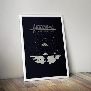 May include: Framed poster with a space-themed illustration. It shows a Kerbal astronaut on a lunar surface, with Earth in the distance. The poster has the text "KERBAL SPACE PROGRAM" at the top, set against a dark blue background.